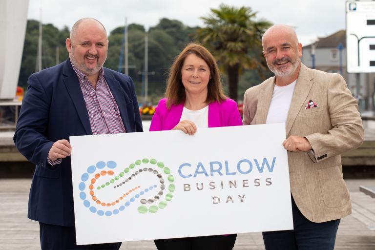 3 People holding a Sign - Carlow Business Day