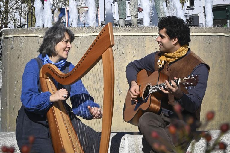 woman with harp and man with guitar