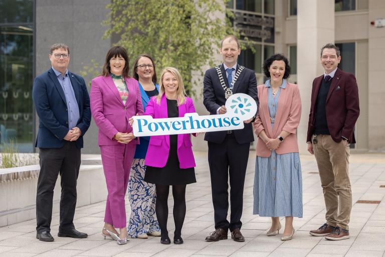 Group of people holding a Powerhouse sign