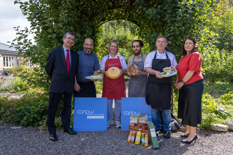 Group standing with bakery produce