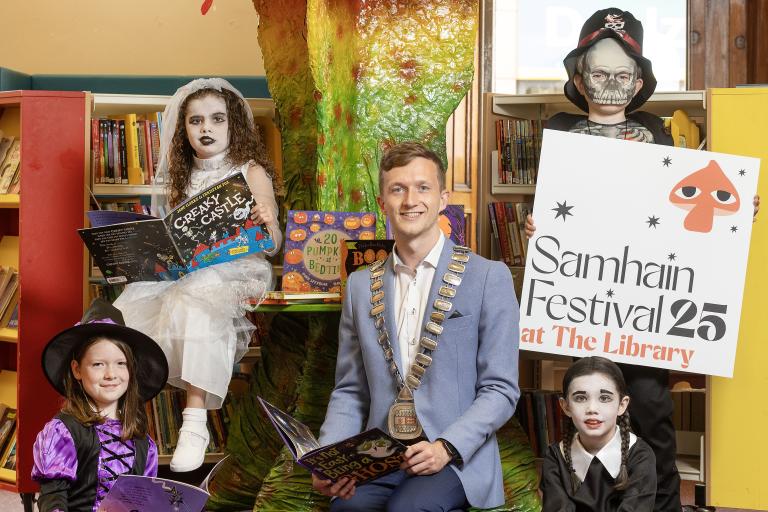 Children in costume with books