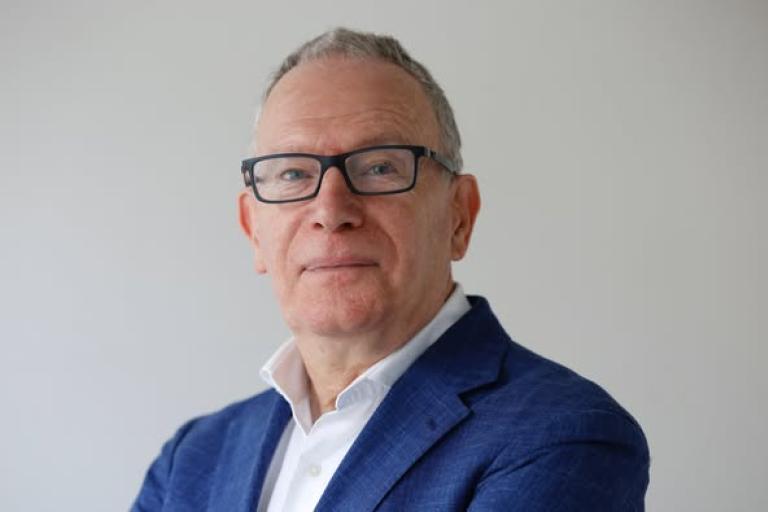 Man with glasses looking at camera