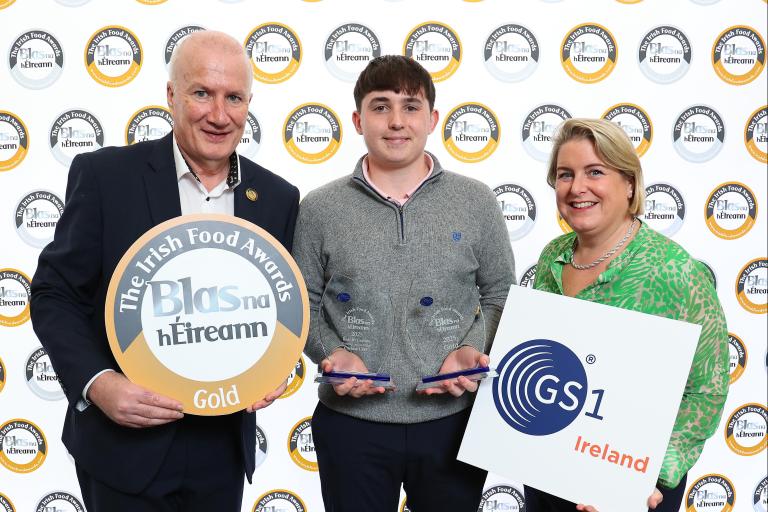 3 people holding awards