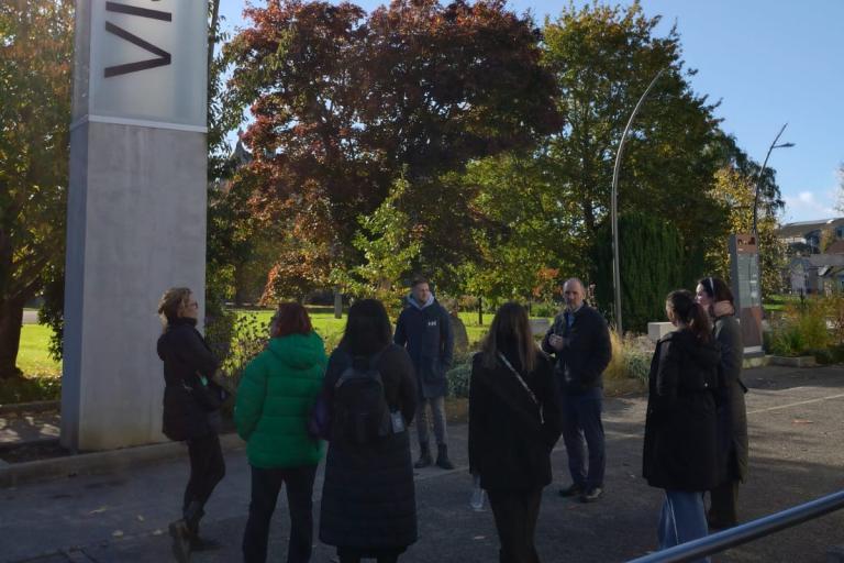 Group standing at sign