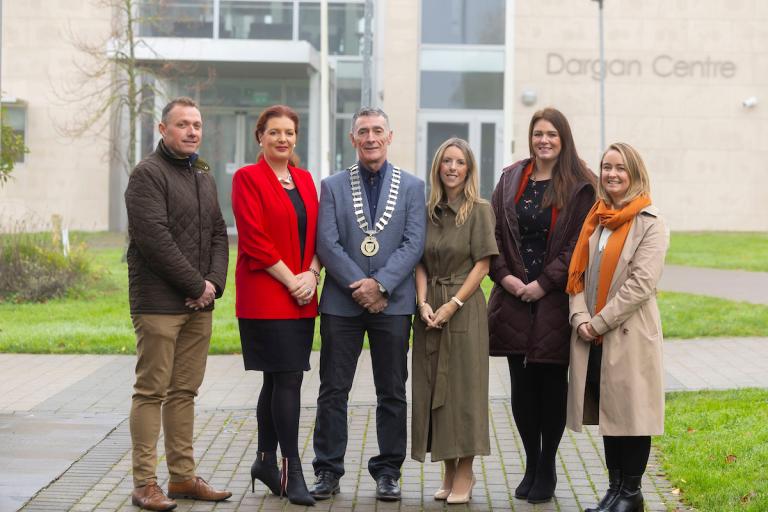 A group standing in front of college