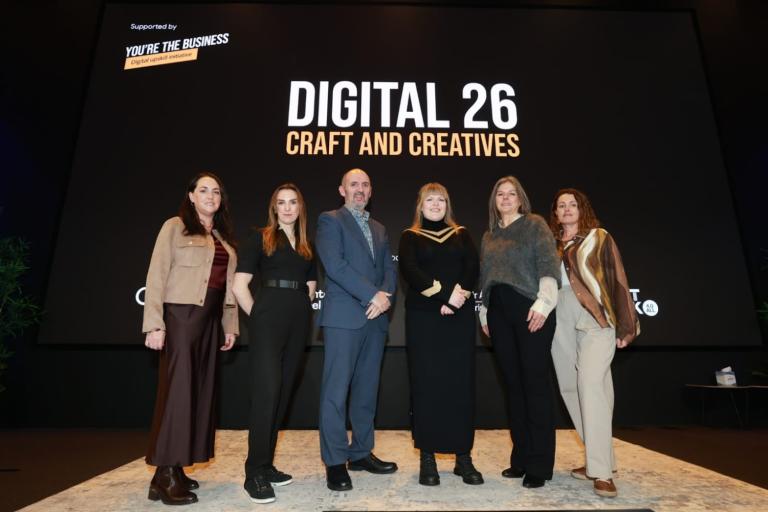 Group standing at Digital 26 Sign