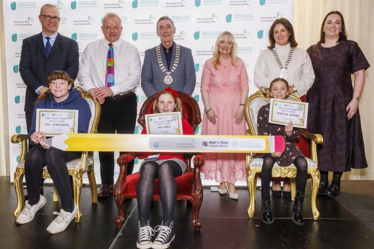 Children sitting and adults standing