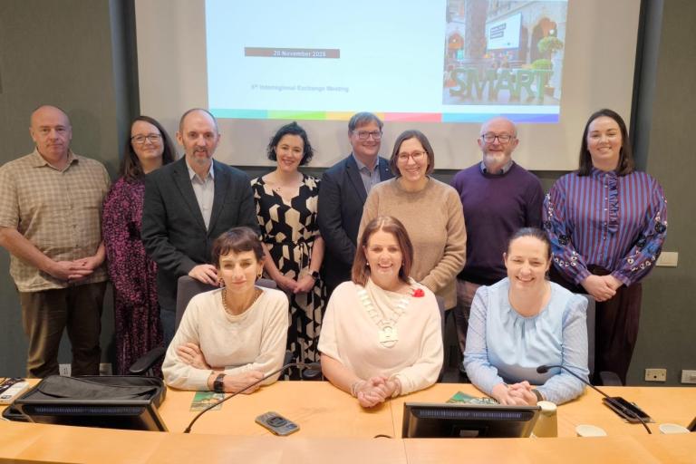 Group sitting in front of large screen