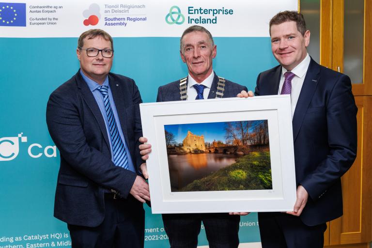 3 Men holding a painting