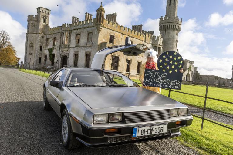 Man standing at old car in front of Ducketts Grove