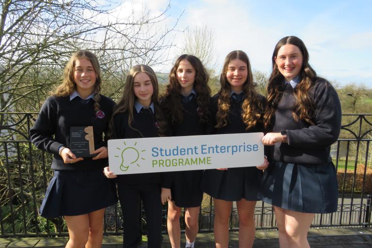 Group of female students with sign