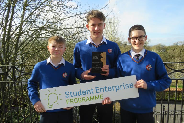 Group of boys with trophy and sign