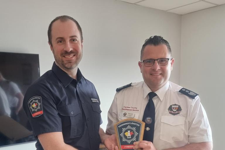 2 Fire Officers with Trophy