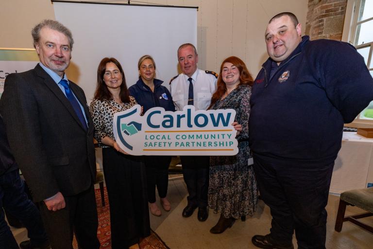 Group holding Carlow Sign