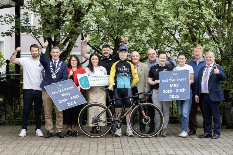 Group standing with bike and cyclist