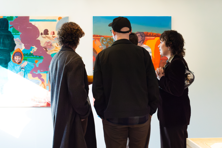 PEOPLE LOOKING AT ART WORK