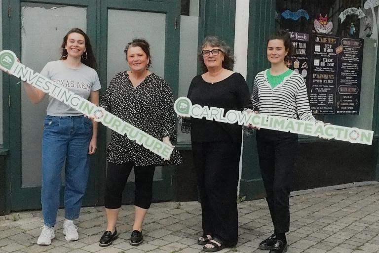 4 Women holding signs