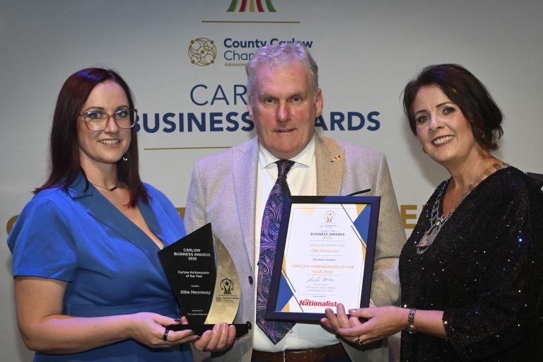 Man and two women holding award