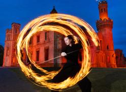 Man in ring of fire and old castle