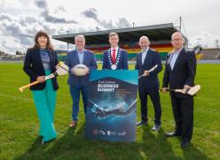 Group with hurls and ball on GAA pitch