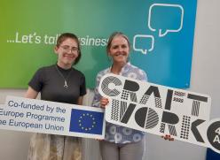 2 People Holding Signs