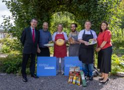Group standing with bakery produce