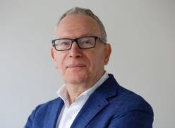 Man with glasses looking at camera