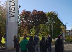 Group standing at sign