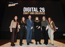 Group standing at Digital 26 Sign