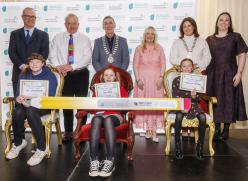 Children sitting and adults standing