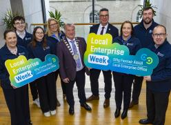 Group standing on landing with signs
