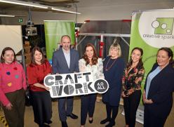 Group holding Craft Work Sign