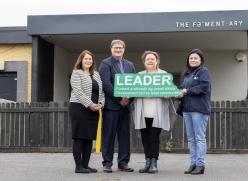 People Holding a Leader Sign