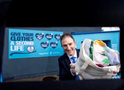 Man holding bag of textiles
