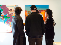 PEOPLE LOOKING AT ART WORK