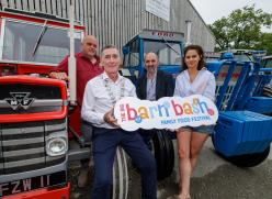 People sitting on tractor holding sign