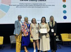 Group standing with certificate