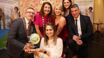 women and men holding award