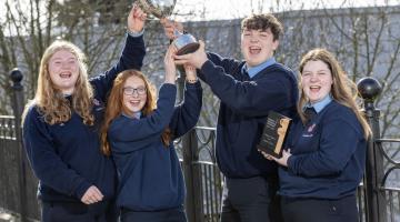 Students Holding a Trophy 