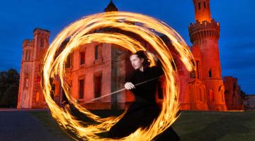 Man in ring of fire and old castle