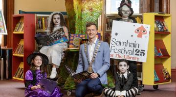 Children in costume in library