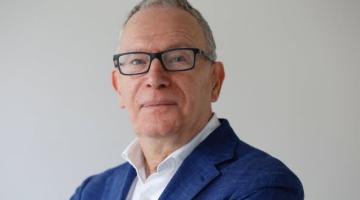 Man with glasses looking at camera