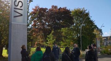 Group standing at sign