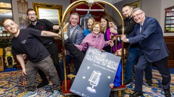 people standing with a luggage trolley