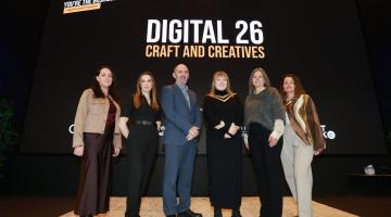Group standing at Digital 26 Sign