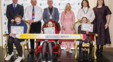 Children sitting and adults standing