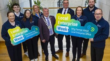 Group standing on landing with signs