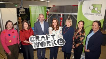 Group holding Craft Work Sign