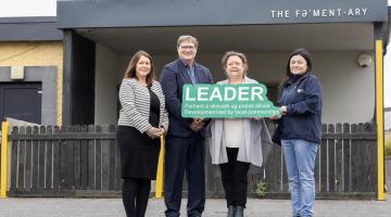 People Holding a Leader Sign