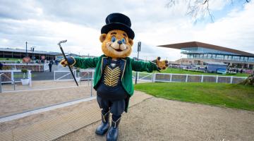 Large teddy bear with top hat and cane